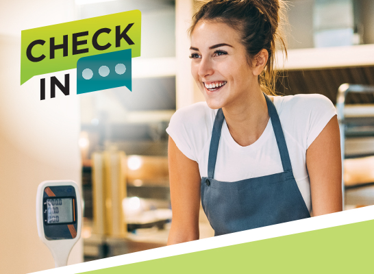 Female retail worker wearing apron smiling Text says 