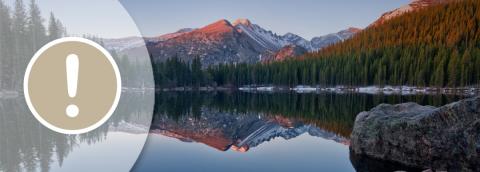 exclamation mark icon over serene mountain lake background banner