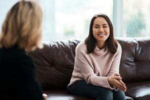Smiling woman on couch during therapy